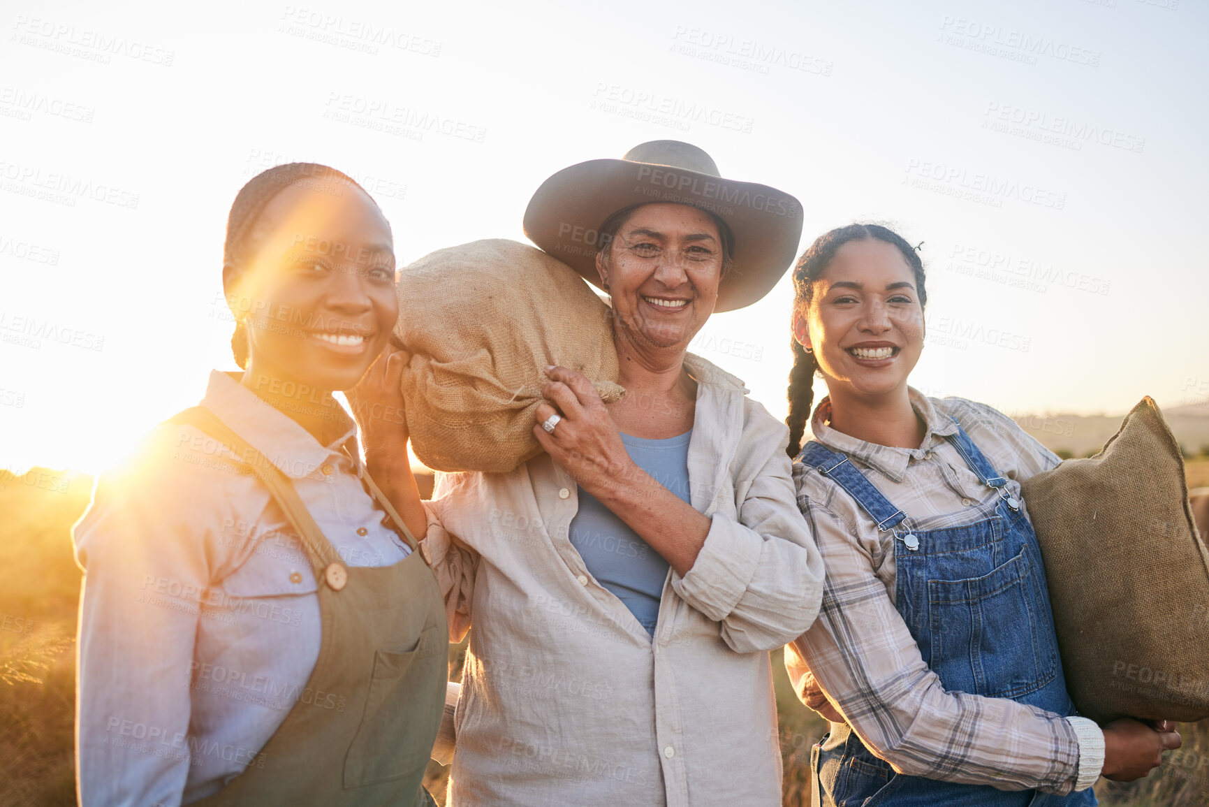 Buy stock photo Women, agriculture and group portrait in field, countryside and bag with smile, harvest and farming in summer. Female teamwork, agro job and helping hand in sunset, nature and outdoor in environment