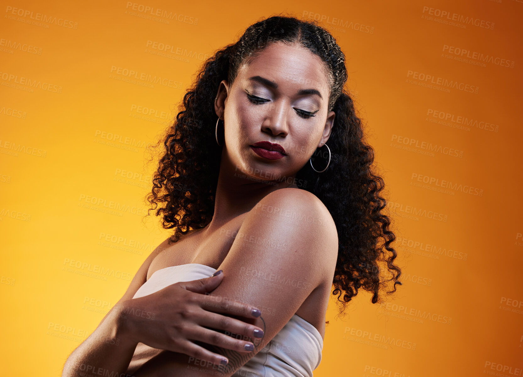 Buy stock photo Beauty, hair and  makeup with face of woman in studio for texture, fashion and cosmetics. Self care, salon and hairstyle with model on orange background for skincare, spa treatment and glow mockup