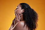 Beauty, curly and hair with profile of woman in studio for texture, makeup and cosmetics. Self care, salon and hairstyle with model on orange background for skincare, spa treatment and glow mockup