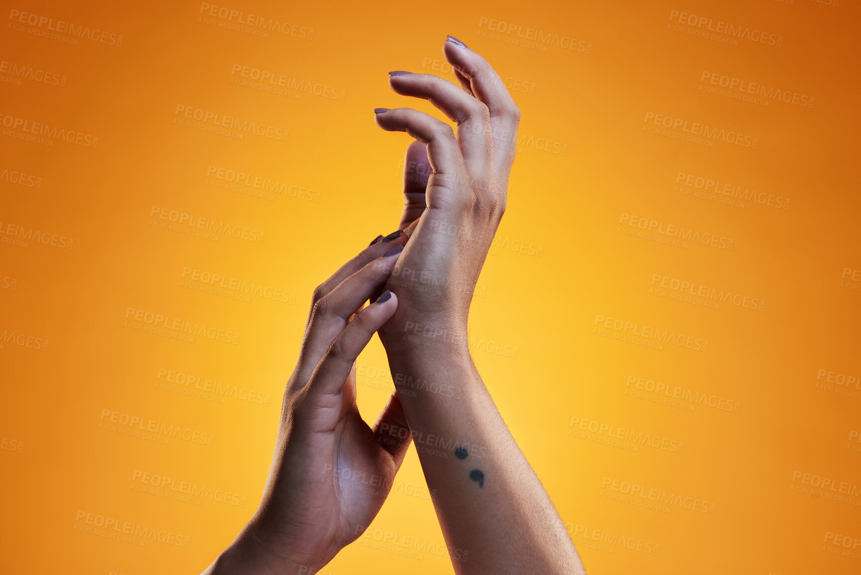 Buy stock photo Hands, touch and skin care of a woman in studio with dermatology cosmetics and a manicure. Beauty salon, spa and a person on an orange background for wellness, health and clean body or hygiene