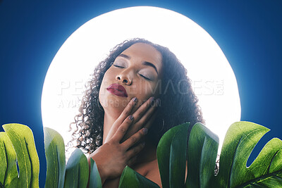 Buy stock photo Beauty, lighting and face of woman with leaf for wellness, natural cosmetics and skincare in studio. Neon circle, creative aesthetic and person for makeup, glamour and facial care on blue background