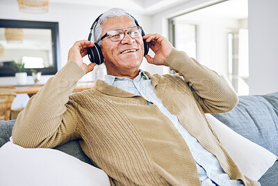 Buy stock photo Senior man, headphones and listening to music in home, living room and relax on lounge sofa with podcast, radio or sound. Streaming, jazz song and audio with earphones and mobile technology in house