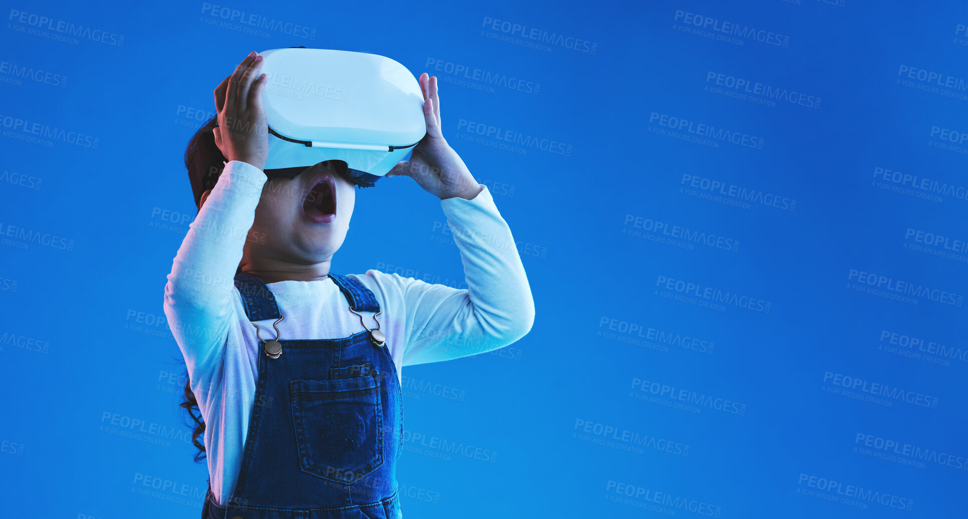 Buy stock photo Future, virtual reality or girl with glasses, metaverse or augmented reality on a blue studio background. Futuristic, kid or child development with vr headset, online gaming or digital transformation