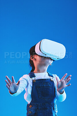 Buy stock photo Metaverse, girl and child virtual reality glasses, innovation and future on a blue studio background. Kid, vr headset or technology for online gaming, futuristic and augmented reality with connection