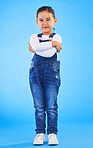 Frustrated, child and arms crossed with tantrum in studio with mockup space. Kid, young girl and angry with cross frown and rejection with a problem and mad attitude with blue background and grumpy