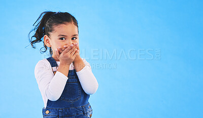 Buy stock photo Girl child, cover mouth and studio portrait with mockup space for promotion, secret or sale by blue background. Female kid, silence and hands on lips for deal, news and fashion model with information