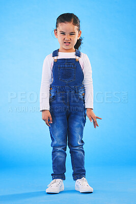 Buy stock photo Angry, attitude and portrait of child on blue background with upset, mad and frustrated facial expression. Behaviour, youth and young girl with body language for anger, tantrum and emotion in studio