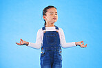 Girl child, zen and meditation in studio with eyes closed, peace and wellness by blue background. Female kid, mindfulness and balance chakra for health, breathing and development with yoga for energy