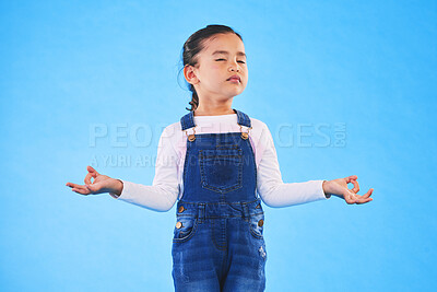 Buy stock photo Girl child, zen and meditation in studio with eyes closed, peace and wellness by blue background. Female kid, mindfulness and balance chakra for health, breathing and development with yoga for energy