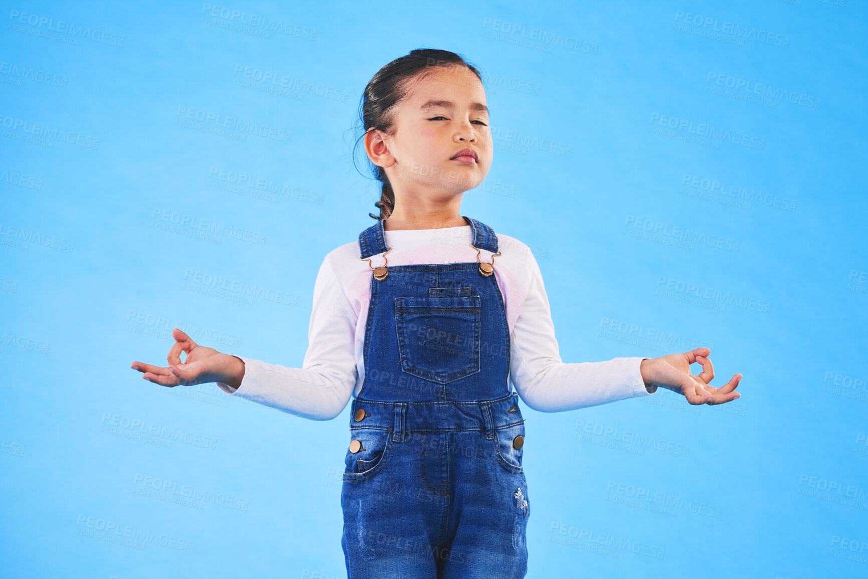 Buy stock photo Girl child, zen and meditation in studio with eyes closed, peace and wellness by blue background. Female kid, mindfulness and balance chakra for health, breathing and development with yoga for energy