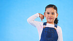 Portrait, girl child and champion, winner and emoji with happiness, strong and excited isolated on blue background. Power, mockup space and winning with success, body language and happy kid in studio