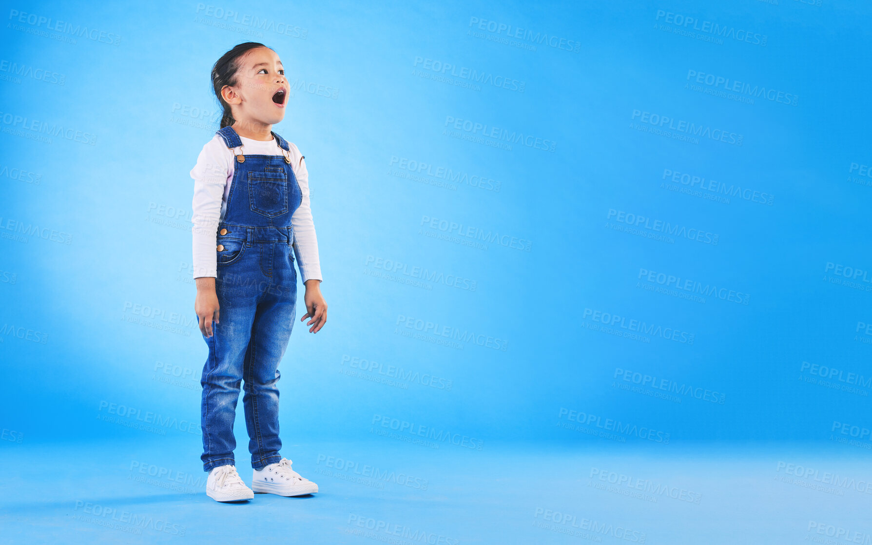 Buy stock photo Shock, surprise and girl child in a studio with mockup space for advertising, promotion or marketing. Wow, wtf and full length of a kid model with omg face expression by blue background with mock up.