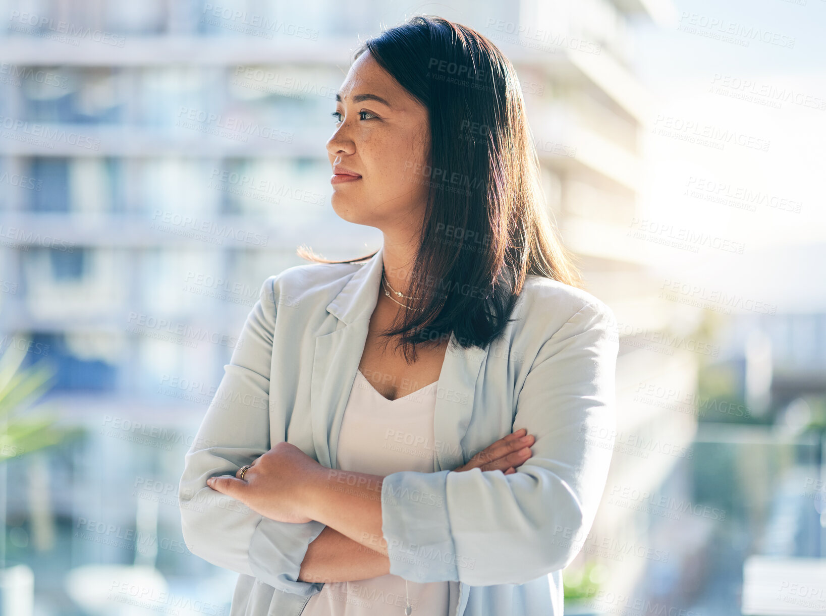 Buy stock photo Thinking, crossed arms and businesswoman in the office with confidence and brainstorming ideas. Young, career and professional Asian female lawyer standing and planning with pride in modern workplace