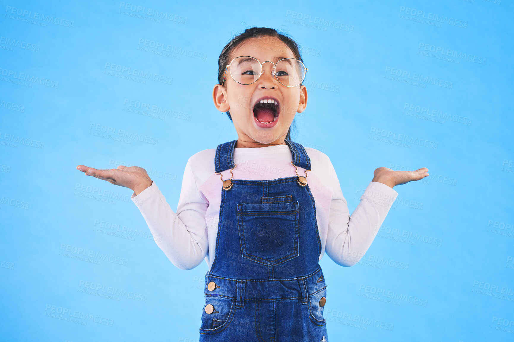 Buy stock photo Excited, happy surprise and girl kid with hand gesture, expression and announcement isolated on blue background. Wow, reaction and happiness, news and opportunity with drama and open mouth in studio