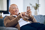 Smile, typing and a senior man with a phone on the sofa for social media, contact or commmunication. Happy, relax and an elderly person on the home couch with a mobile for an app or reading a chat