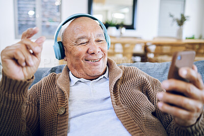 Buy stock photo Phone, senior man and watch music video, streaming podcast and reading happy story, news article or retirement blog. Home, smartphone and elderly person with headphones, relax and listening to song