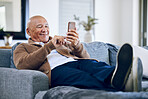 Smile, relax and a senior man with a phone on the sofa for social media, contact or commmunication. Happy, online and an elderly person on the home couch with a mobile for an app or typing a chat