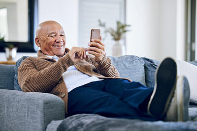 Buy stock photo Smile, relax and a senior man with a phone on the sofa for social media, contact or commmunication. Happy, online and an elderly person on the home couch with a mobile for an app or typing a chat