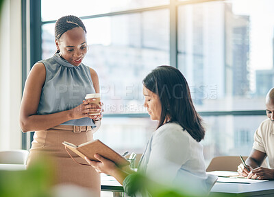 Buy stock photo Collaboration, agenda and notebook with business woman planning their schedule or calendar in the office. Teamwork, diversity and a professional employee reading a journal or diary with her colleague
