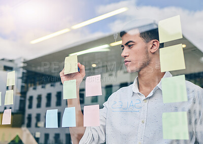 Buy stock photo Glass, window and man, brainstorming and writing on sticky note, project management and strategy in workplace. Ideas, planning and business with moodboard, calendar and goals with productivity