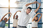 Team building, stretching and a group of business people in the office to workout for health or mobility together. Exercise, fitness and training with an employee group in the workplace for a warm up