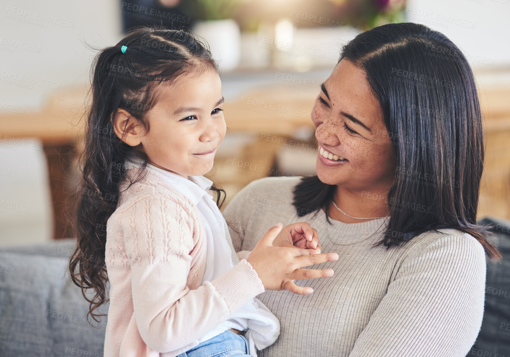 Buy stock photo Hug, happy and playful with mother and daughter on sofa for love, care and support. Funny, calm and relax with woman and young girl embrace in living room of family home for peace, cute and bonding