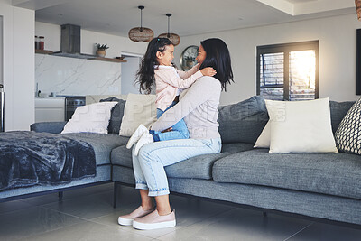 Buy stock photo Relax, happy and playful with mother and daughter on sofa for love, care and support. Funny, calm and smile with woman and young girl embrace in living room of family home for peace, cute and bonding