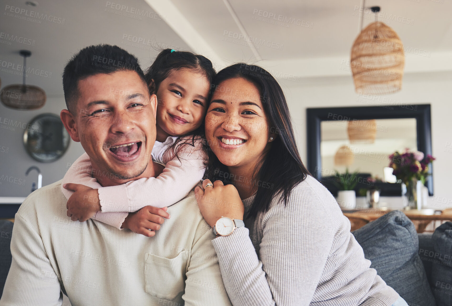 Buy stock photo Hug, smile and portrait of girl with her parents bonding together in the living room of their home. Care, love and child holding her father and mother while relaxing in the lounge of a family house.