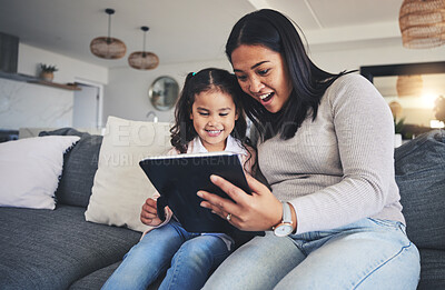 Buy stock photo Tablet, surprise and a mother on the sofa with her daughter in the living room of their home together. Wow, family or children with a mother and girl looking at social media or a good news email