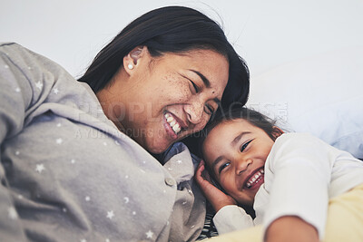 Buy stock photo Laugh, mother and daughter in bed at home with love, care and happiness in morning. A young woman and girl child together in a bedroom for fun time, playing and security or relax in a family house