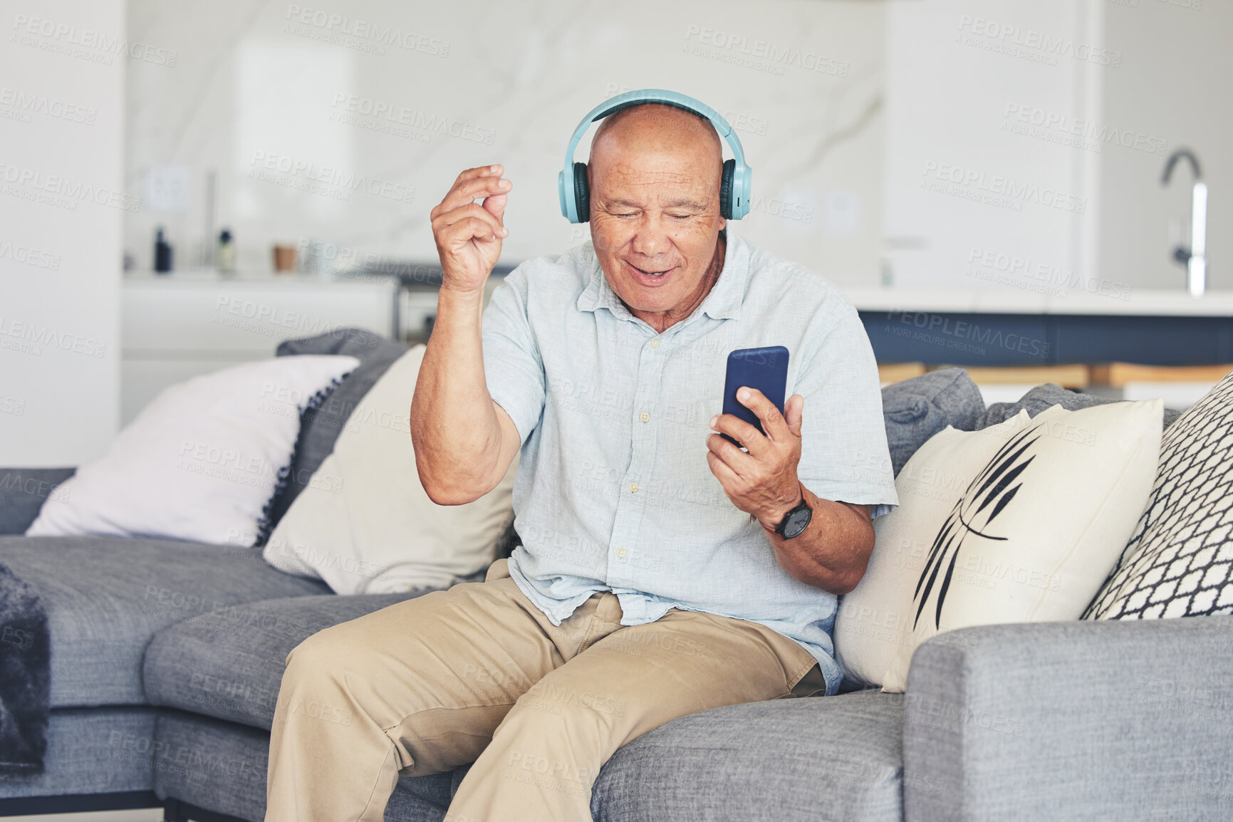 Buy stock photo Headphones, phone and old man in living room dancing on sofa, listening to streaming radio and relax. Music, fun and excited senior person on couch with cellphone, earphones and online in retirement.