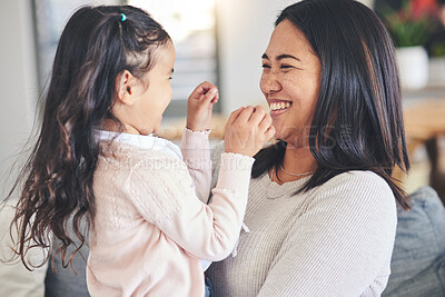 Buy stock photo Funny, happy and playful with mother and daughter on sofa for love, care and support. Smile, calm and relax with woman and young girl embrace in living room of family home for peace, cute and bonding