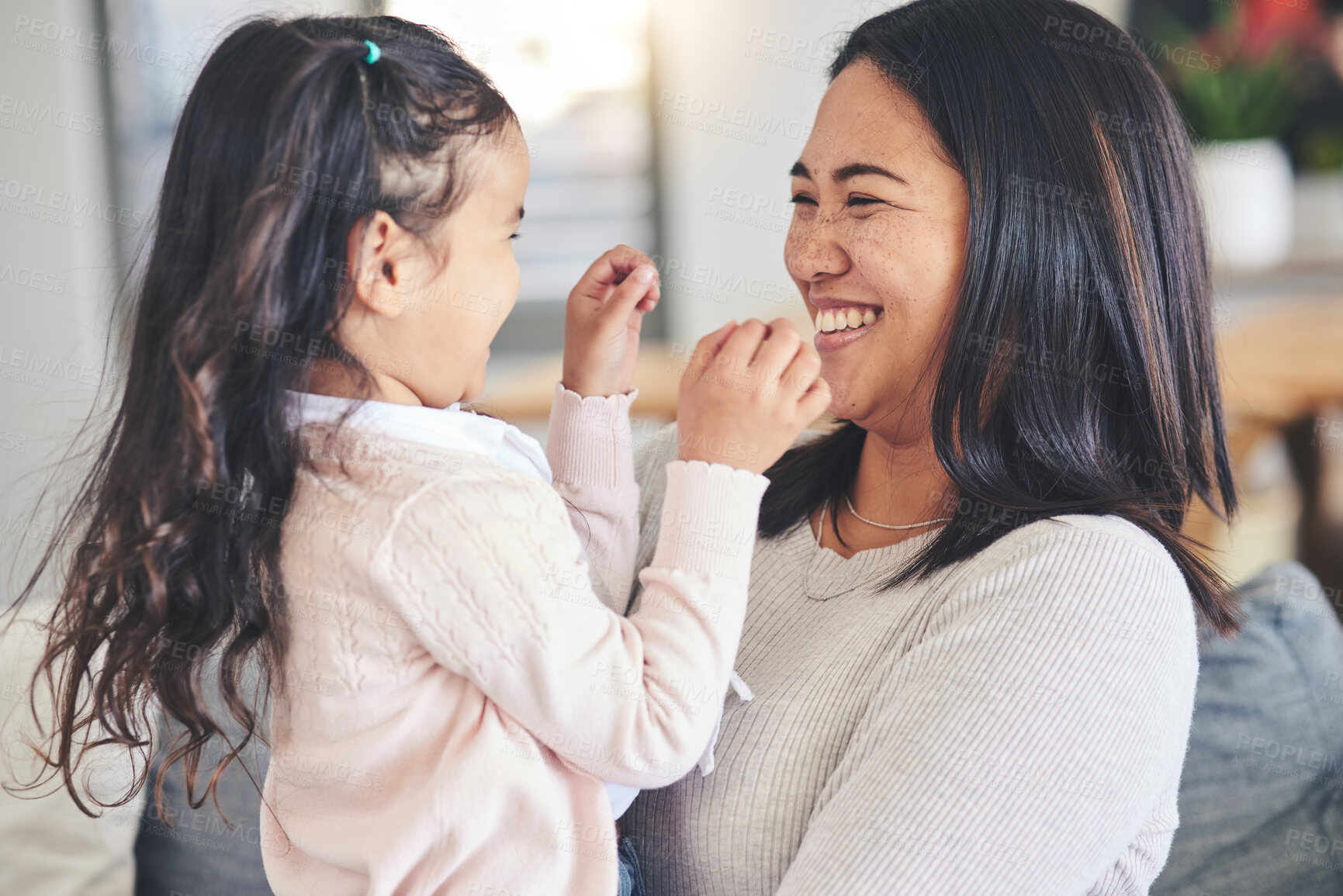 Buy stock photo Funny, happy and playful with mother and daughter on sofa for love, care and support. Smile, calm and relax with woman and young girl embrace in living room of family home for peace, cute and bonding