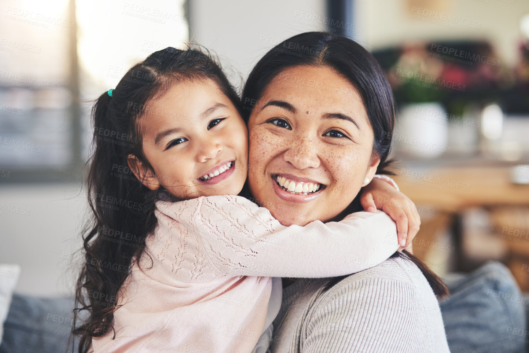 Buy stock photo Smile, mother and daughter hug for a portrait at home with love, care and happiness. A young woman and girl child together on a lounge sofa for fun time, playing and security or relax in family house