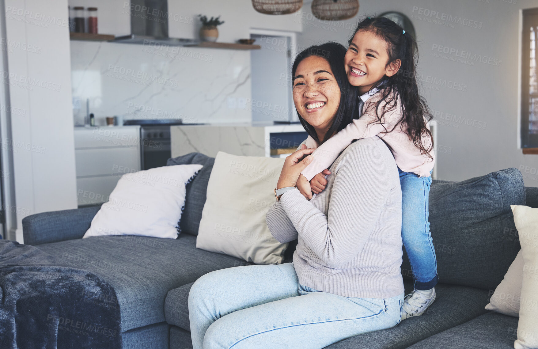 Buy stock photo Hug, happy and love with mother and daughter on sofa for playful, care and support. Smile, calm and relax with woman and young girl embrace in living room of family home for peace, cute and bonding