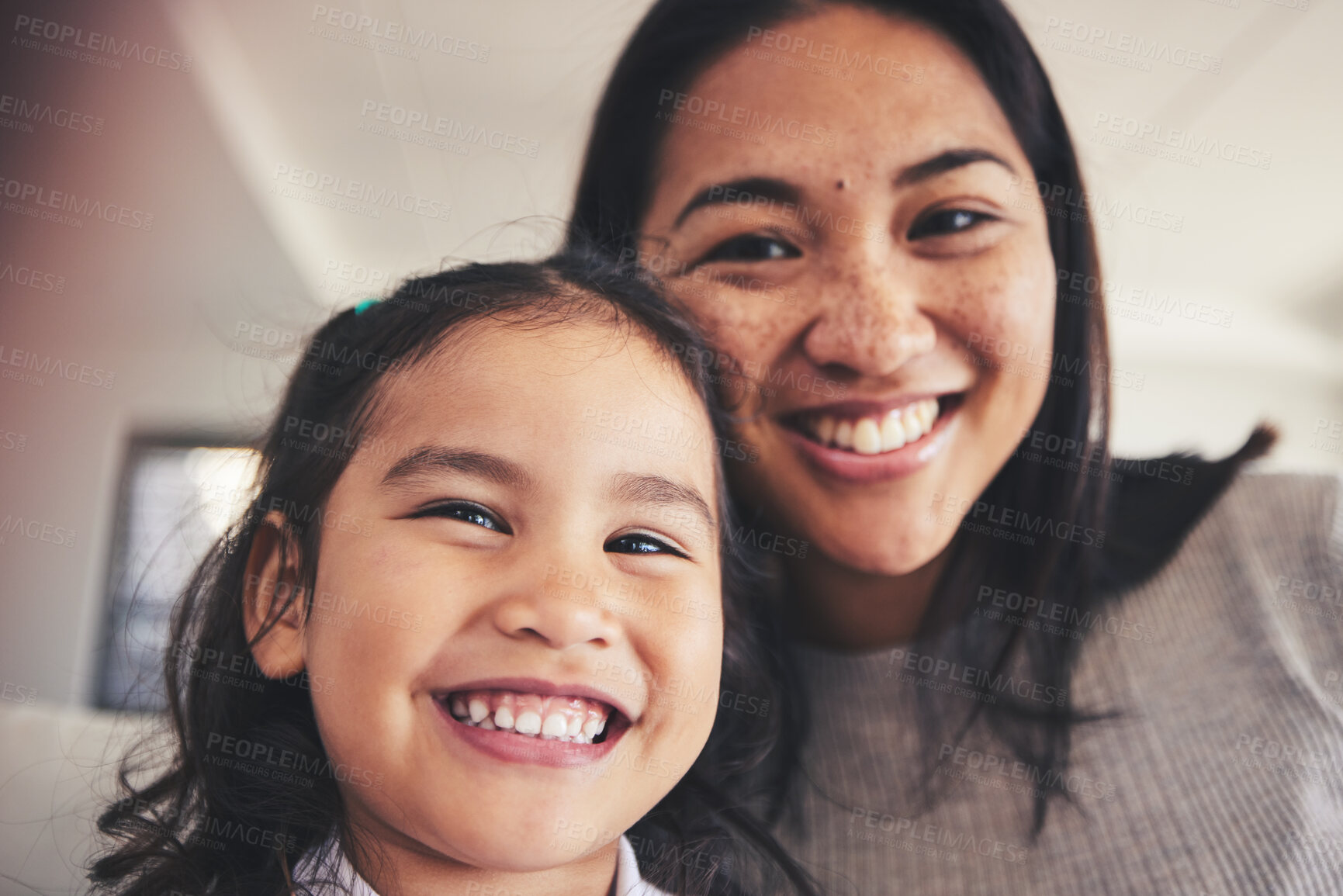 Buy stock photo Selfie, smile and portrait of a girl with her mother bonding in the living room of their home. Happy, love and face headshot of Asian child taking a picture with her young mom at their family house.