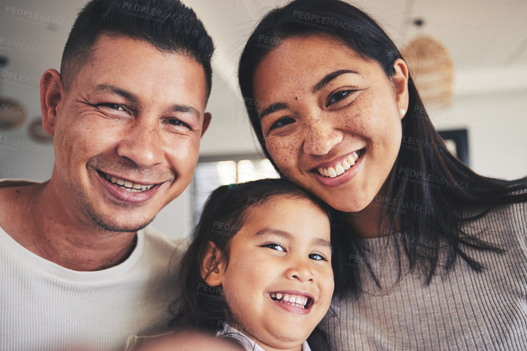 Buy stock photo Selfie, happy and portrait of a child with her parents bonding in the living room of their home. Smile, love and girl kid taking a picture with her interracial mother and father at their family house