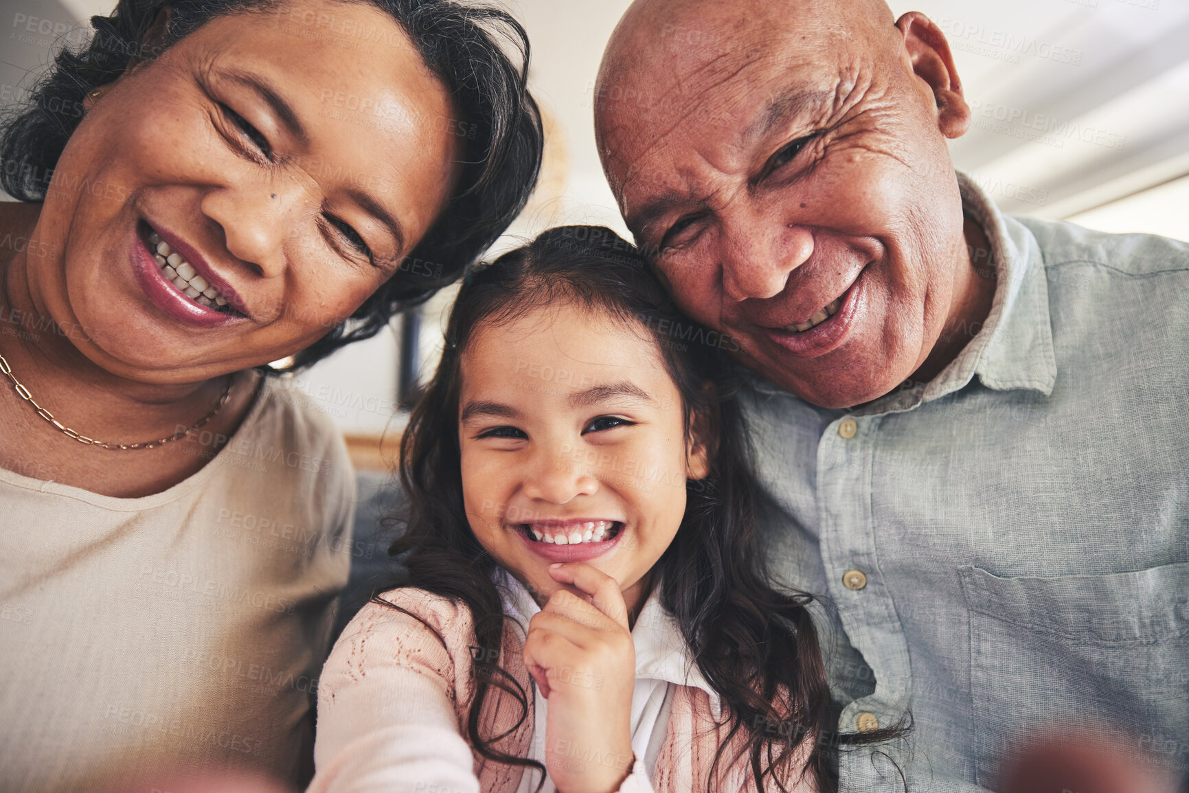 Buy stock photo Portrait, selfie or happy grandparents with girl child in living room bonding together as a family in Mexico. Profile picture, faces or grandmother with grandfather or kid at home on holiday vacation