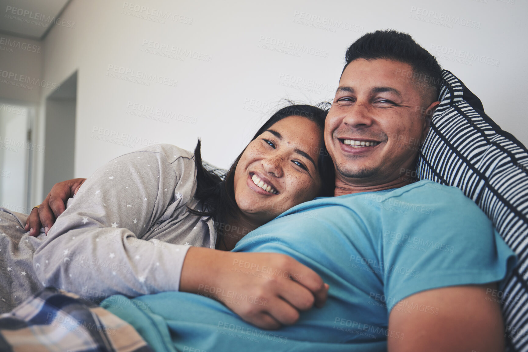 Buy stock photo Portrait, bed or happy couple hug in house with smile, care or support while bonding to relax together. Morning, man or woman lying in home bedroom with love, peace or loyalty in marriage commitment