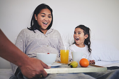 Buy stock photo Surprise, breakfast and mother with child in bed relaxing on weekend morning at their home. Happy, smile and young mom enjoying healthy food for brunch meal with her daughter for mothers day in house