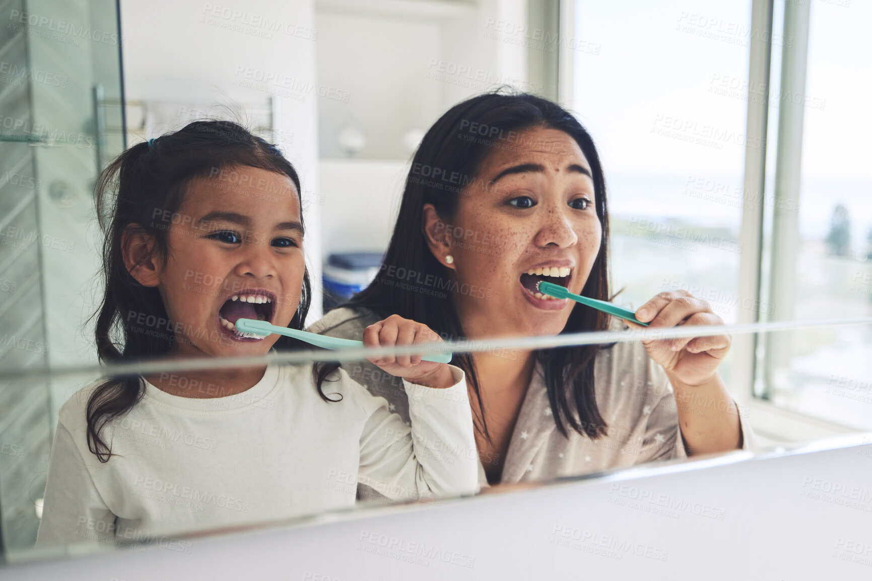 Buy stock photo Mother, child and brushing teeth in dental hygiene, morning routine or healthcare together by mirror in bathroom. Happy mom and daughter cleaning mouth in tooth whitening, oral or gum care at home