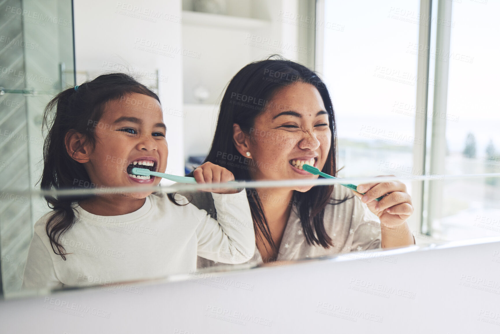 Buy stock photo Mother, child and brushing teeth in morning routine, dental hygiene or healthcare together by mirror in bathroom. Happy mom and daughter cleaning mouth in tooth whitening, oral or gum care at home