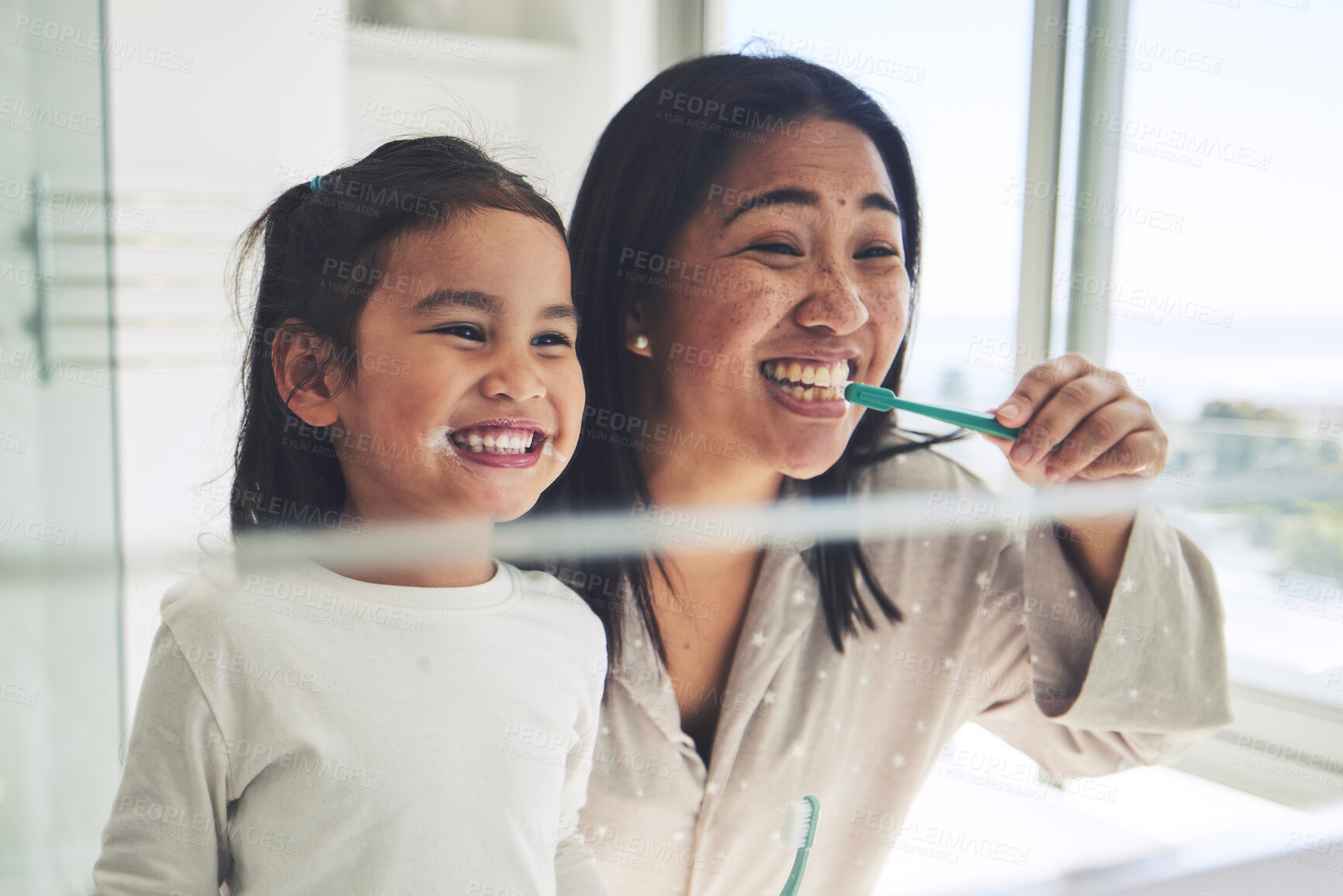 Buy stock photo Mother, happy kid or brushing teeth in dental hygiene, morning routine or healthcare by mirror in bathroom. Mom, smile or daughter cleaning mouth in tooth whitening, oral or gum care at home together