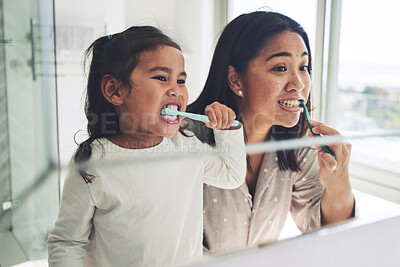 Buy stock photo Mother, child and brushing teeth in dental cleaning hygiene, morning routine or healthcare together by mirror in bathroom. Happy mom and daughter mouth in tooth whitening, oral or gum care at home