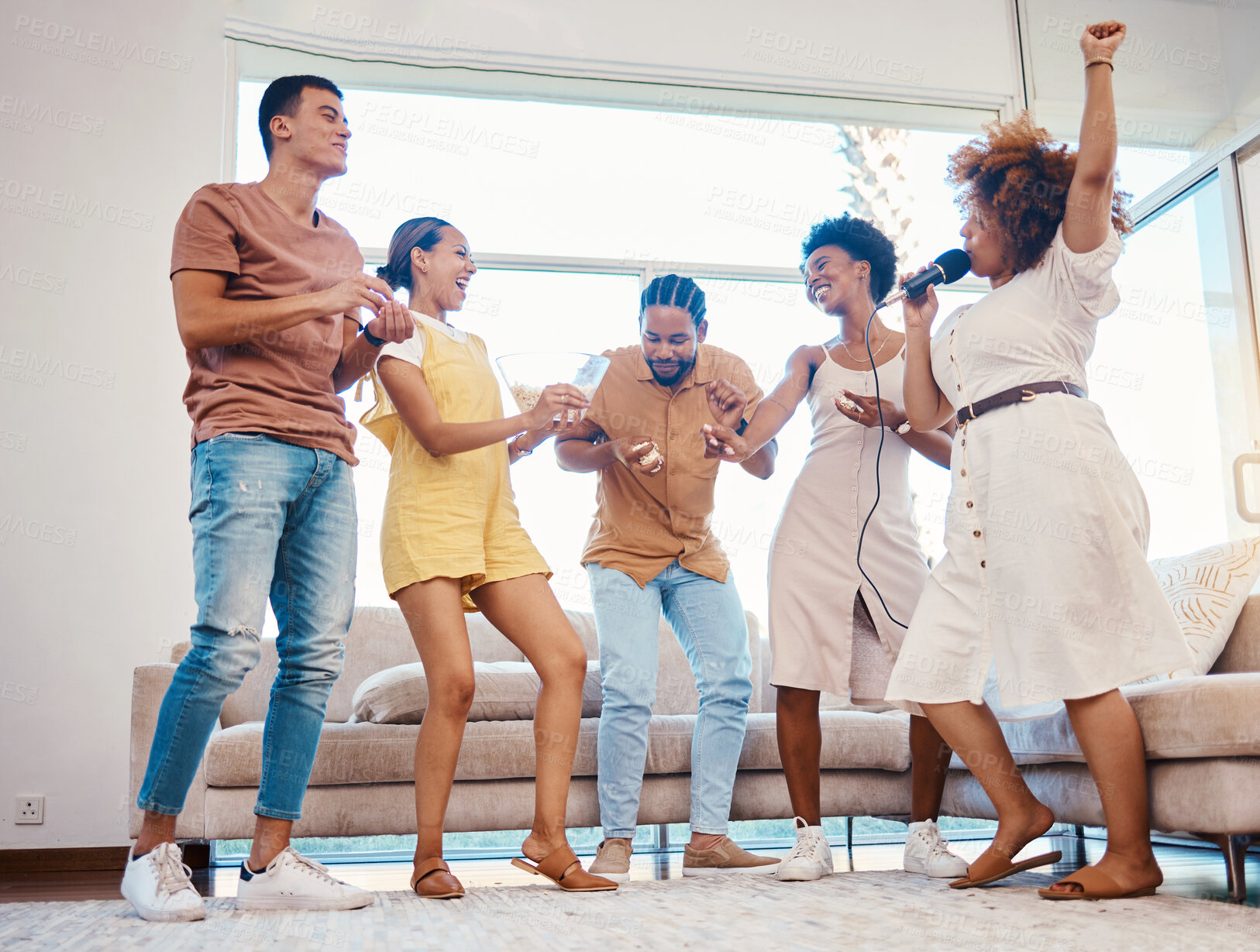 Buy stock photo Karaoke, party and friends dancing in the living room with a microphone to music, playlist or radio. Happy, diversity and young people singing, moving and having fun together for bonding at home.