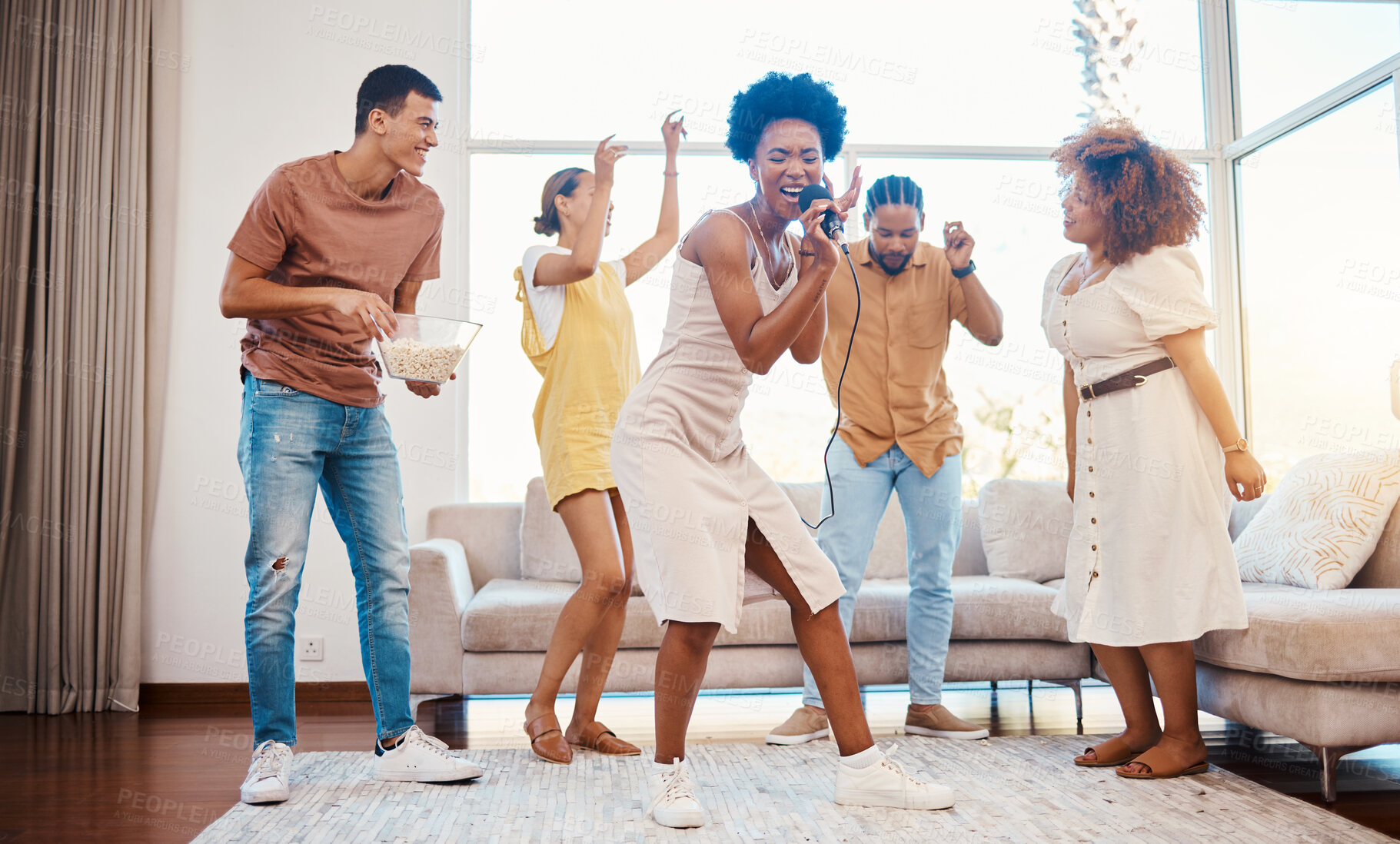 Buy stock photo Singing, music and friends doing karaoke in the living room with microphone to playlist or radio. Happy, diversity and young people dancing, bonding and having fun together for entertainment at home.