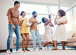 Karaoke, entertainment and friends singing in the living room with a microphone to music, playlist or radio. Happy, diversity and young people dancing, bonding and having fun together at an apartment