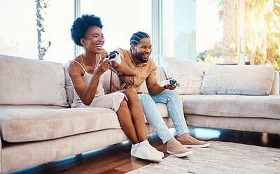 Buy stock photo Gaming, funny and a black couple on a sofa in the living room of their home together for bonding. Love, fun or leisure with a gamer man and woman playing online using a console in their house