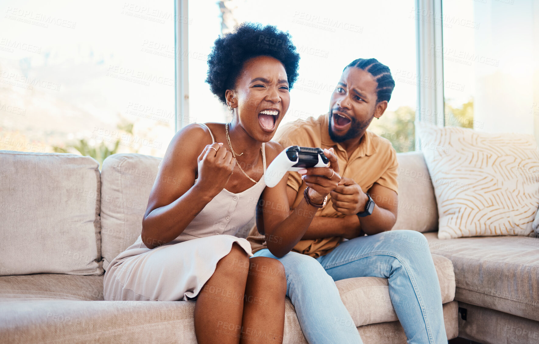 Buy stock photo Gaming, winner and a black couple on a sofa in the living room of their home together for bonding. Love, fun or competition with a gamer man and woman playing online using a console in their house