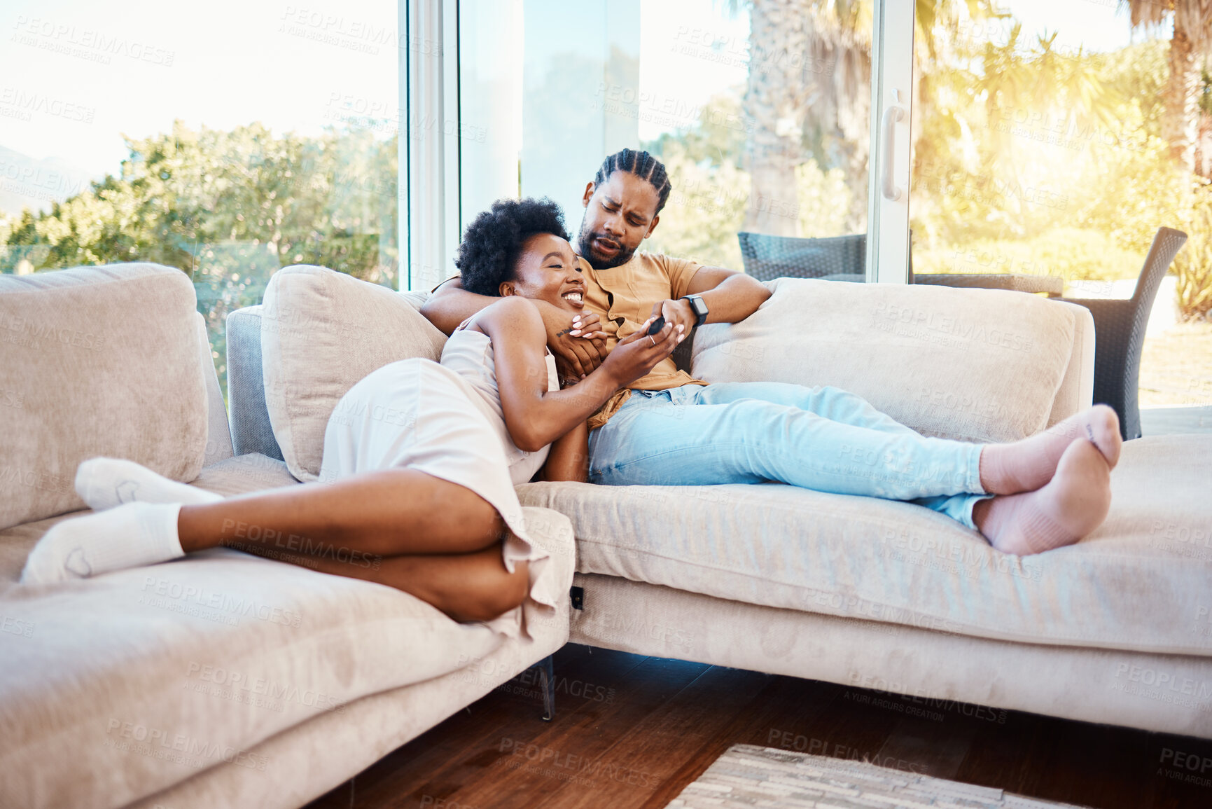 Buy stock photo Happy, relax and a black couple on the sofa, watching tv and talking in a house. Smile, love and an African man and woman with care, speaking and conversation on the living room couch for a movie